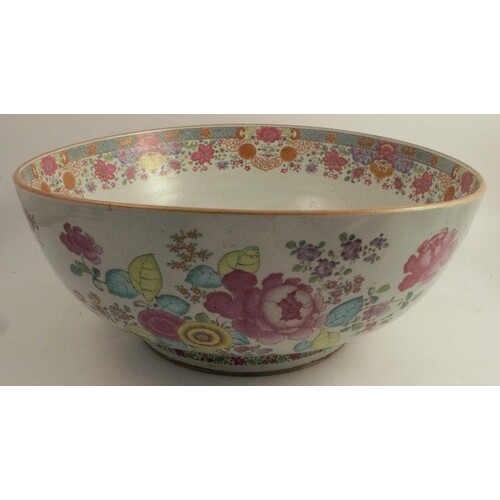 A massive Chinese export punch bowl decorated in famille ros...