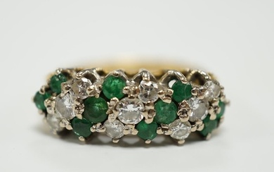 A modern 18ct, emerald and diamond set cluster half hoop rin...