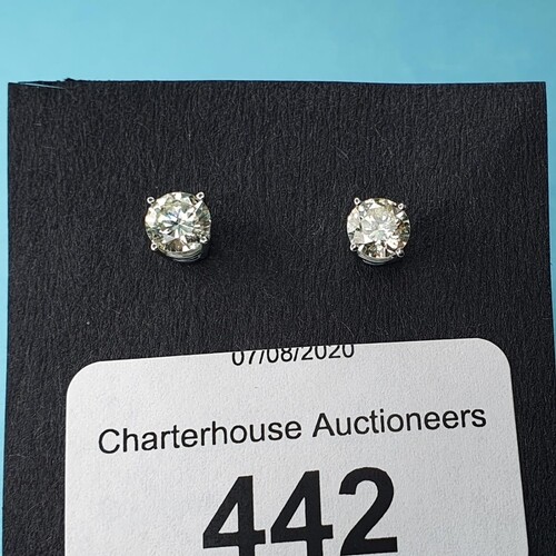 A pair of 18ct white gold screw back solitaire diamond studs...