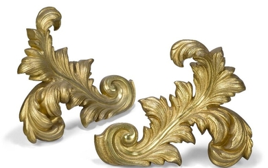 A pair of French gilt-bronze chenets, early 20th century, each in the form of an acanthus leaf, with iron supports, 25cm high, 33cm wide (2)