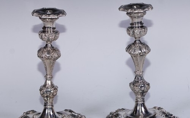 A pair of George II style electro-plated table candlesticks,...