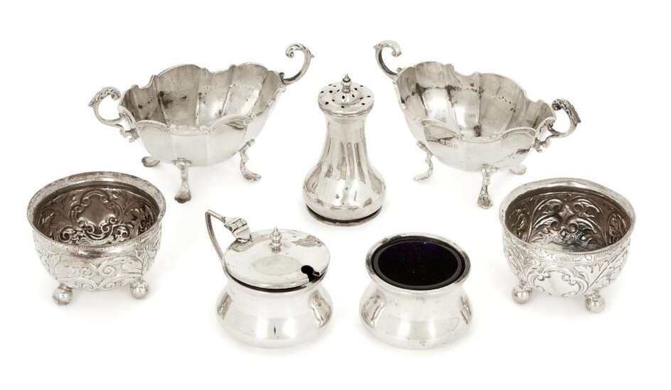 A pair of Victorian silver salt cellars, London, 1890, Horace Woodward & Co., both with repousse bodies and raised on four ball feet, liners deficient, together with a pair of Edwardian silver twin-handled navette-shaped salts by Henry Matthews...