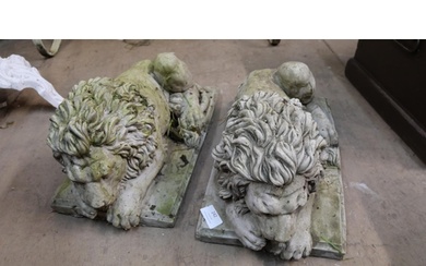 A pair of concrete garden figures of recumbent lions