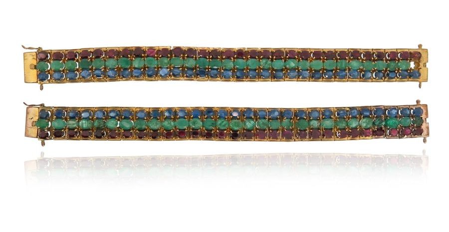 A pair of gem-set gold bracelets, each set...