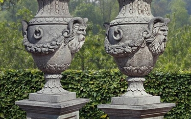 A pair of impressive carved limestone urns