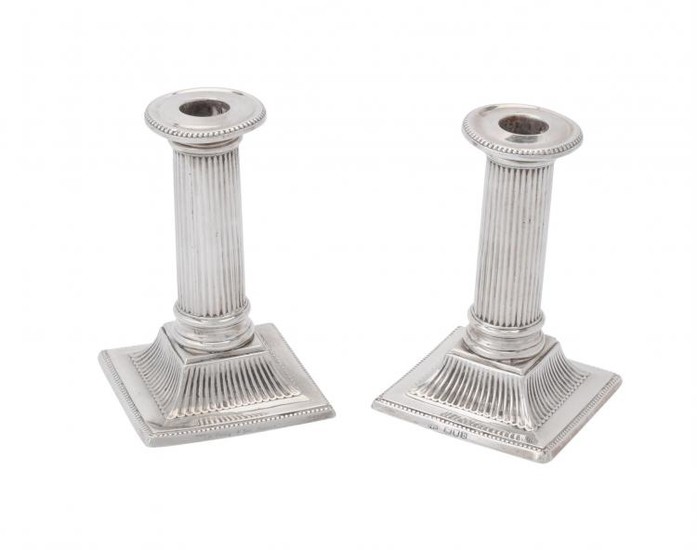 A pair of late Victorian silver small square candlesticks by Charles Stuart Harris
