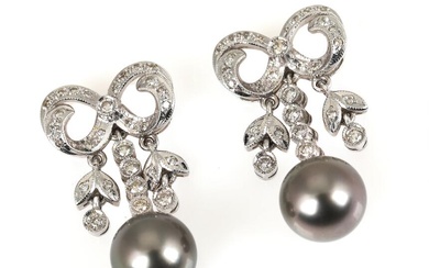 A pair of pearl of diamond ear studs each set with a...