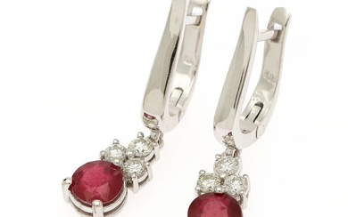 A pair of ruby and diamaond ear pendants each set with a circular-cut ruby ant three brilliant-cut diamonds, mounted in 14k white gold. L. 28 mm. (2)