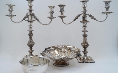 A pair of silver plated three light candelabra, on knopped and foliate decorated stems and shaped bases, 48.5cm high; together with a silver plated basket with sunflower and fruiting vine border and swing handle, on circular foot, 30cm diameter;...