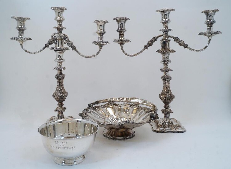 A pair of silver plated three light candelabra, on knopped and foliate decorated stems and shaped bases, 48.5cm high; together with a silver plated basket with sunflower and fruiting vine border and swing handle, on circular foot, 30cm diameter;...