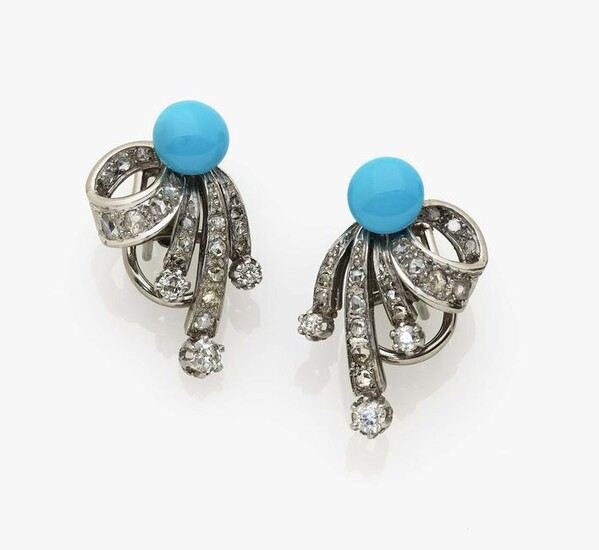 A pair of stud earrings with diamonds and turquoises
