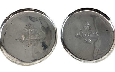 A pair of white metal pin dishes decorated with palm...