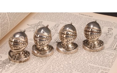 A set of four Victorian Gothic Revival silver novelty pepper...