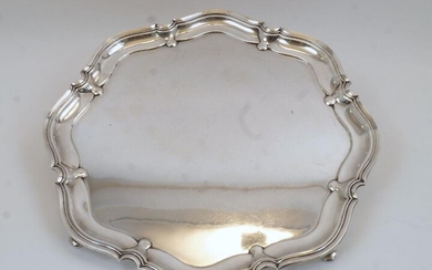 A silver salver, Sheffield, 1945, Atkin Brothers, with scalloped rim, on four pad feet, 35.5cm diameter, weight approx. 43.9oz