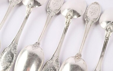 A suite of twelve silver teaspoons, the handle finished in an ogive with waves, rosettes and palmettes.