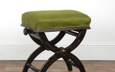 Aesthetic movement ebonised stool with green upholstery and carved decoration...