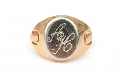 A 14 karat gold two tone signet ring. The shank made of rose gold and the shield in white gold. Engraved with a monogram, 'A H'. Gross weight: 12 g.