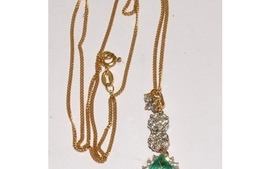 An 18ct gold emerald and diamond pendant on 18ct gold chain....