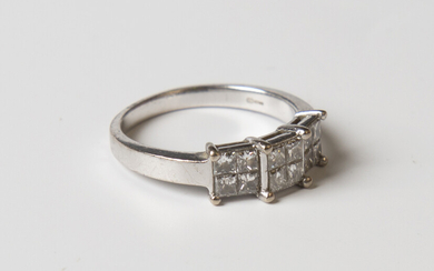 An 18ct white gold and diamond ring, designed as three four stone diamond clusters, mounted with pri