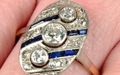 An Art Deco platinum and 14ct gold vari-cut diamond and sapphire geometric ring.Principal diamonds