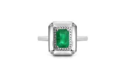 An Art Deco style 18ct white gold (stamped 750) ring set with an emerald cut emerald surrounded by brilliant cut diamonds and mother of pear