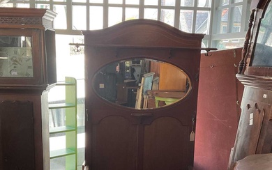 An Edwardian inlaid mahogany hall stand with oval bevelled mirror...