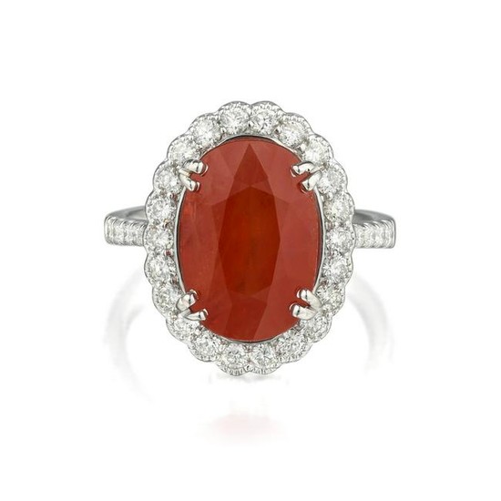 An Orange Sapphire and Diamond Ring