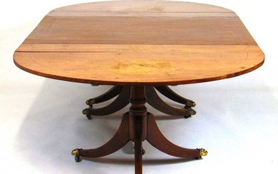 An early 19th century mahogany three pod dining table, the...