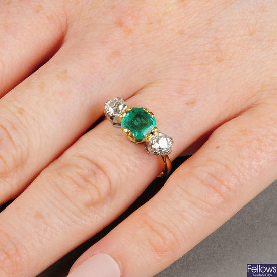 An emerald and old-cut diamond three-stone ring.