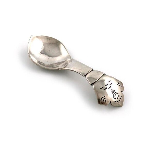By H. G. Murphy, an Arts and Crafts silver caddy spoon, London 1928, shaped oval bowl, spot-hammered decoration, the shaped handle with engraved decoration, length 9.7cm, approx. weight 0.5oz.