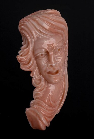 Cerasuolo coral sculpture featuring a woman face in carved...