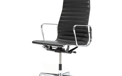 Charles Eames, Ray Eames: “Aluminium Group”. High backed aluminium office chair on castors. Upholstered with black leather. Manufactured by Vitra.