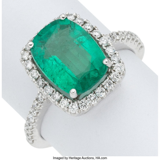 Emerald, Diamond, White Gold Ring The ring features a...