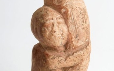 Erotic limestone statuette representing a man holding his...