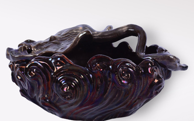 HELMER OSSLUND. A bowl with a reclining swan, glazed earthenware, Höganäs, (1896-1897).