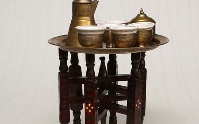 ORIENTAL SMALLER COFFEE TABLE with brass tray, folding wooden base, matching COFFEE POT, SUGAR BOWL, and 6 pcs, CUP HOLDERS, with Chinese porcelain inserts. The last quarter of the 20th century.