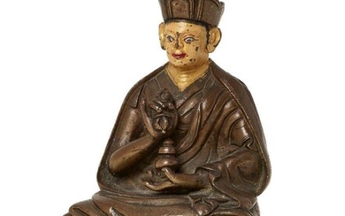Property of a Gentleman (lots 36-85) A Tibetan copper alloy figure of a Karmapa, 18th century, wearing a three-peaked crown with painted face and features, holding a vajra in his right hand to his chest and a jar in his left hand in his lap seated...