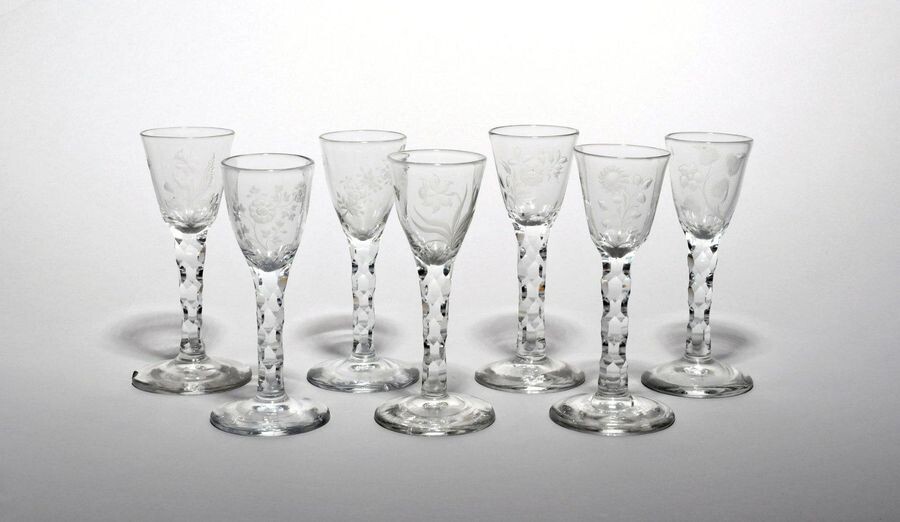 Seven wine glasses c.1770, each rounded funnel bowl engraved with...