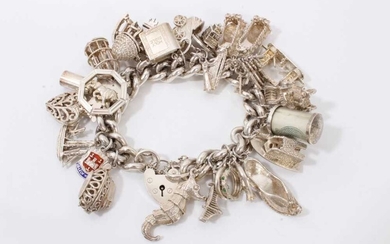 Silver charm bracelet with large quantity of silver and white metal novelty charms