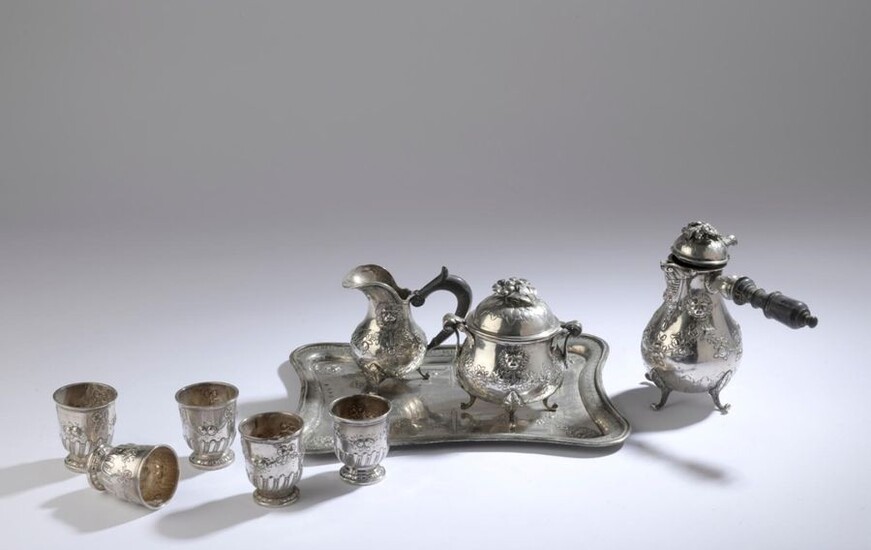 Silver coffee service decorated in repoussé with lion mufles and garlands of flowers including: a coffee pot, a covered sugar bowl, a creamer, a rectangular tray.