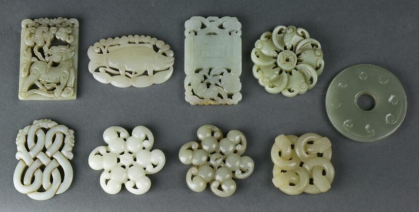 (lot of 9) A group of nine Chinese carved jade pendants