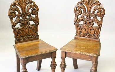 A PAIR OF VICTORIAN OAK HALL CHAIRS, with carved backs