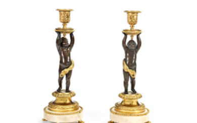 A pair of 19th century and later patinated and gilt bronze and white marble figural figural candlesticks