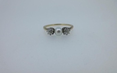 A diamond and pearl three stone ring
