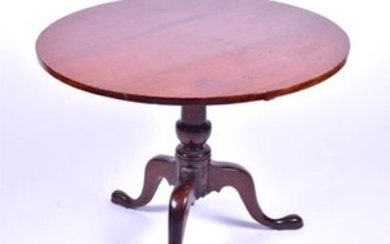 A George III mahogany tilt top supper table with turned column support above three cabriole legs with pad feet, 90 cm diameter....