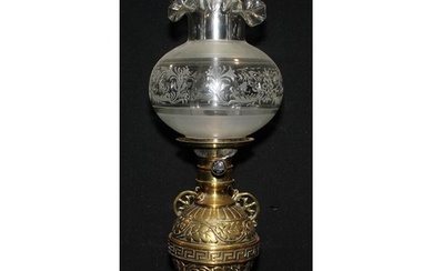 A 19th century brass wall mounted globular oil lamp, cast wi...