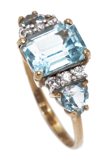 A 9CT GOLD TOPAZ AND DIAMOND RING; centring an approx. 3ct emerald cut blue topaz between shoulders each set with a pear cut blue to...