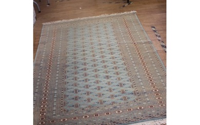 A Bokhara rug, pale green ground with wide multi banded bord...
