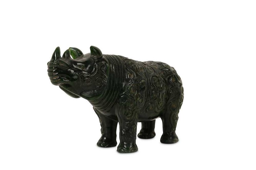 A CHINESE SPINACH GREEN JADE 'RHINOCEROS' CARVING.