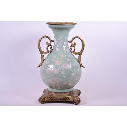 A Chinese celadon glazed porcelain vase with ormolu style mo...
